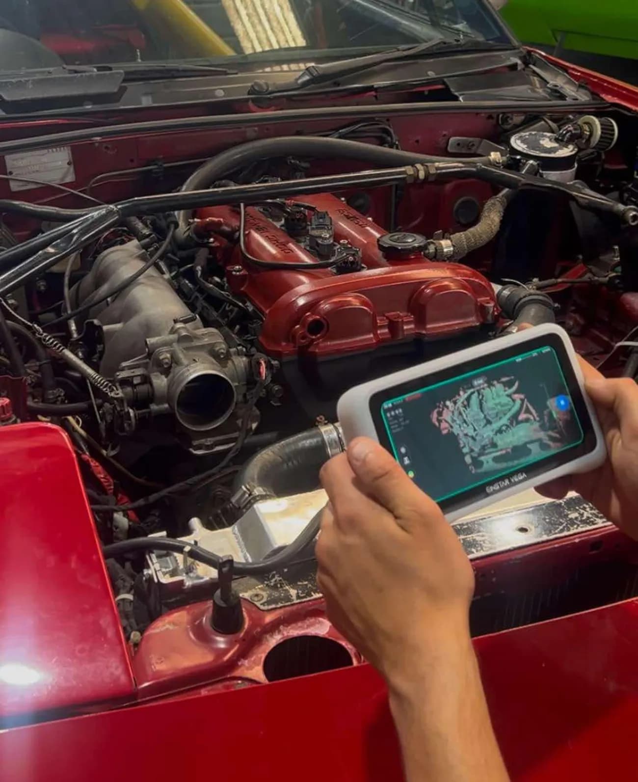 Handheld 3D scanner capturing an engine bay